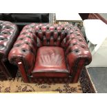 A Chesterfield style oxblood club armchair,