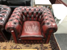 A Chesterfield style oxblood club armchair,