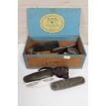 A box of antique collectables to include cased spectacles, pipes, tape measures, OXO tin,