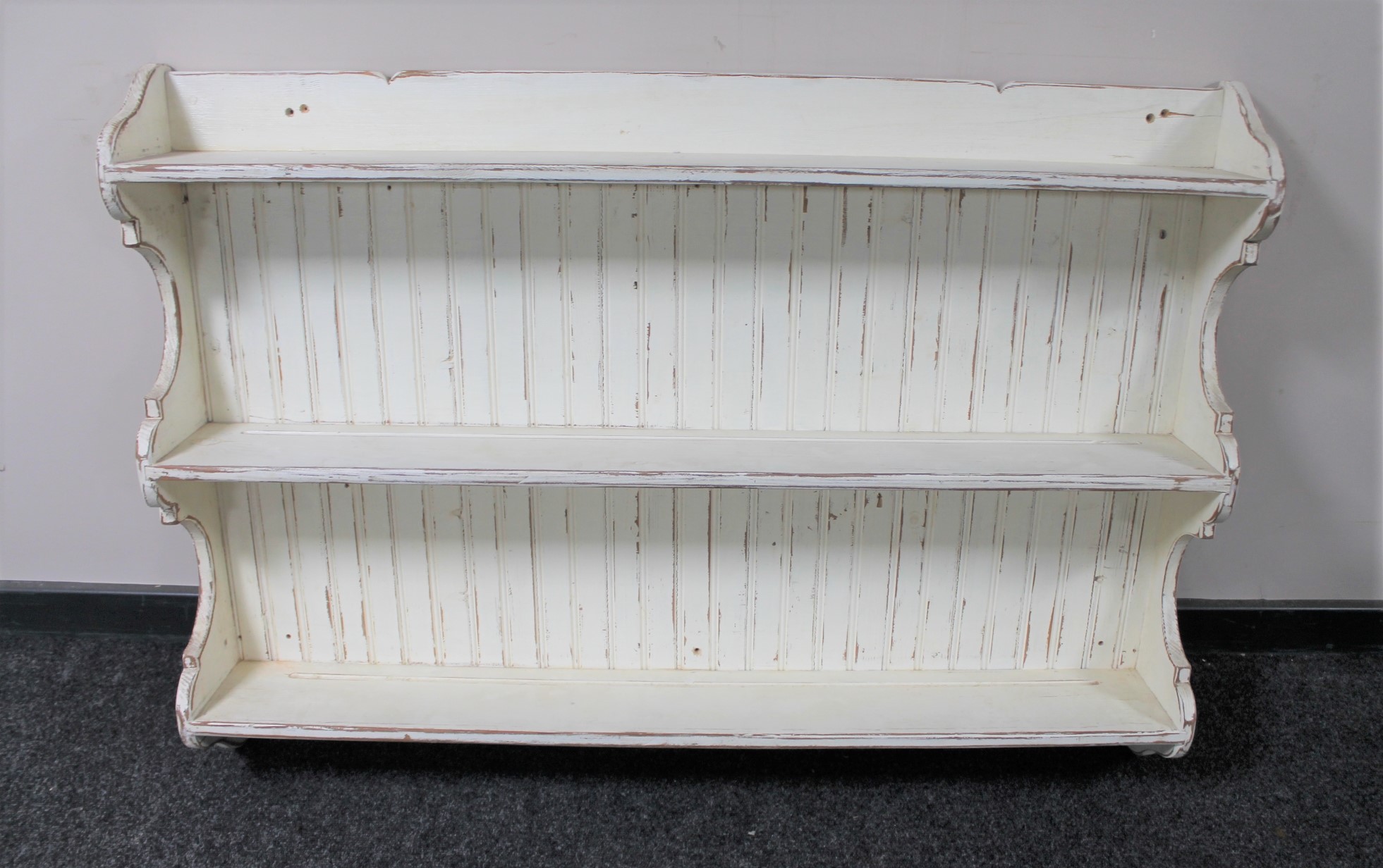A painted pine kitchen plate rack in distressed finish