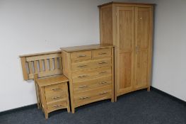 A four piece contemporary oak bedroom suite; double wardrobe, six drawer chest,