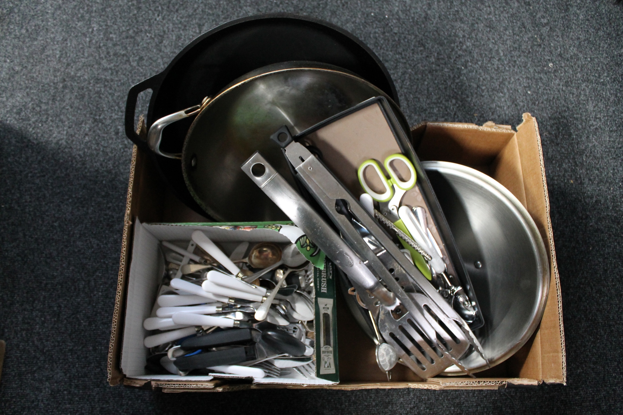 A box of assorted cutlery, cooking utensils,
