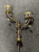 An antique brass two branch candle holder CONDITION REPORT: Height 60cm. width 45cm.