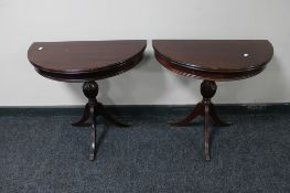 A pair of Regency style demi-lune occasional tables