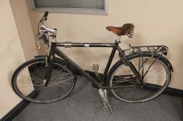 A gent's MBK Octane Plus hybrid bike with vintage Brooks saddle (rear wheel locked)