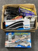 A boxed Scalextric digital advanced 6 car power base together with a further box of track and