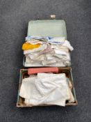 A vintage case and a box containing vintage linen, doilies,