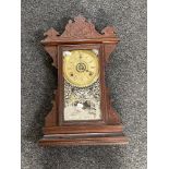 An antique American Buffalo mantel clock by The Gilbert Clock Company