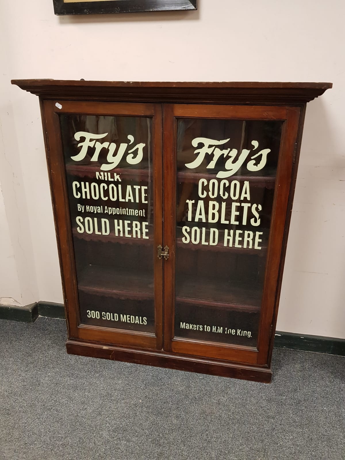 A Victorian and later mahogany display cabinet with Fry's chocolate advertising, width 104 cm.