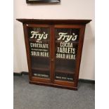 A Victorian and later mahogany display cabinet with Fry's chocolate advertising, width 104 cm.