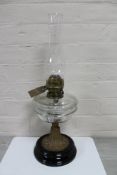 A Victorian Duplex oil lamp with clear glass reservoir and chimney