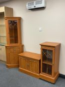 A pine effect corner display cabinet,