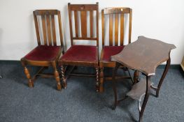 A shaped Edwardian occasional table and three oak dining chairs