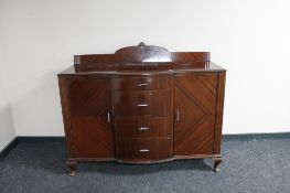 A 1930's mahogany bow fronted sideboard fitted with two cupboards