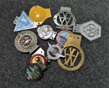 A collection of chrome car badges; AA badge,