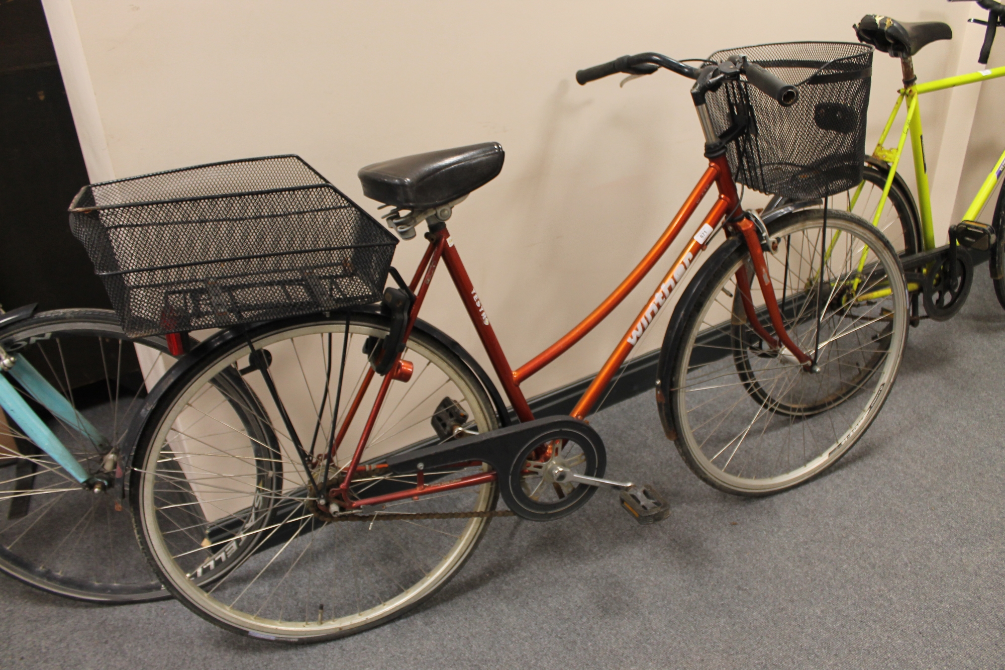 A lady's Winther Tesro hybrid bike with front and rear shopping baskets (rear wheel locked)