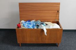 A mid century blanket box containing linen,