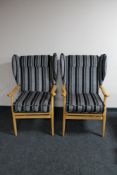 A pair of beech framed wing armchairs in striped fabric