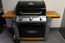 An Outback three-burner gas BBQ, with cover.