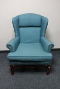A Carolina Sofa Factory wingback armchair in turquoise fabric