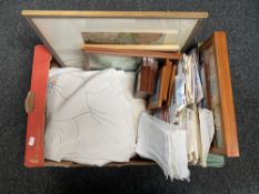 A box of assorted framed prints, vintage knitting patterns,