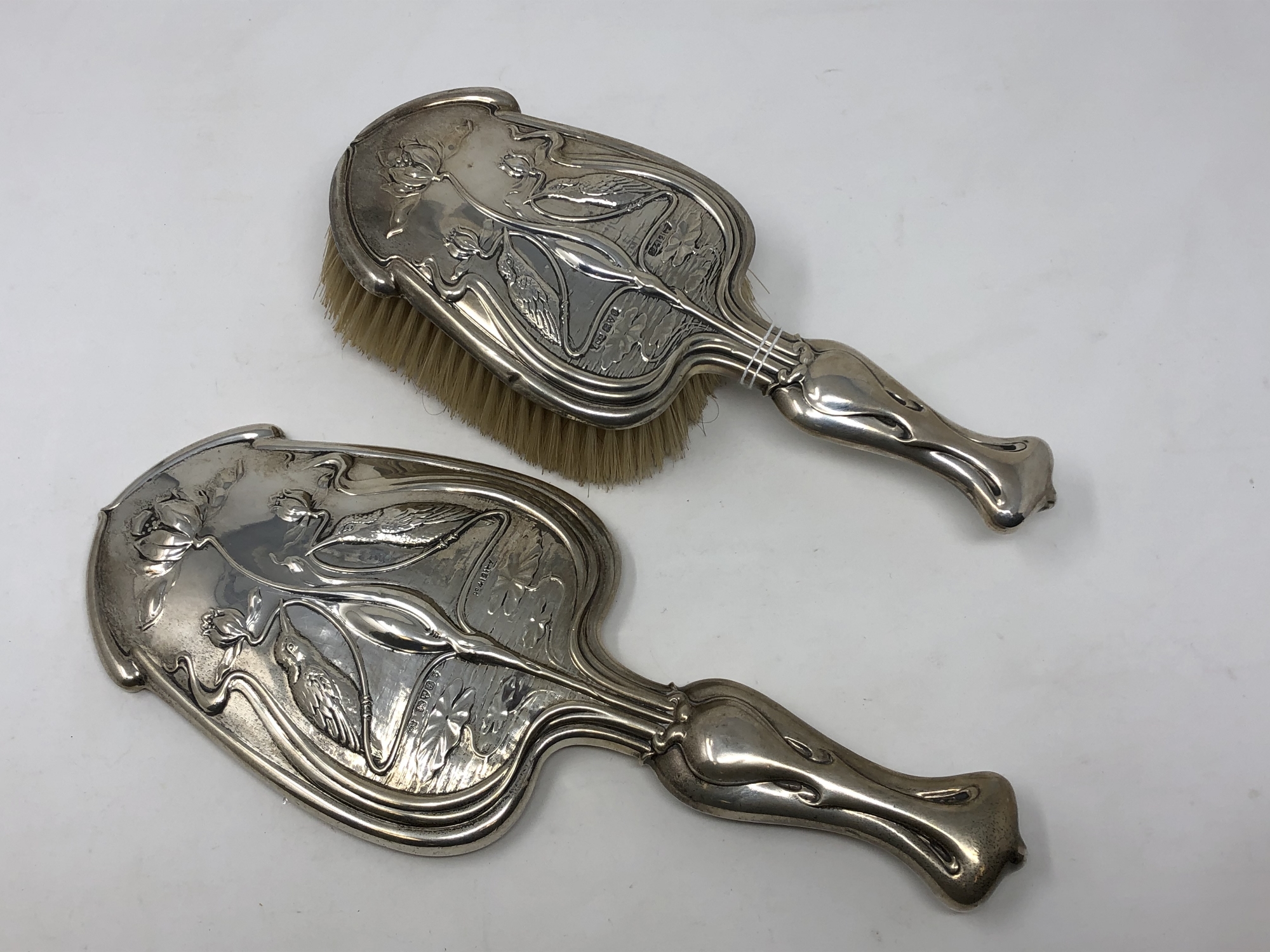 A fine quality Art Nouveau brush and hand mirror depicting kingfishers