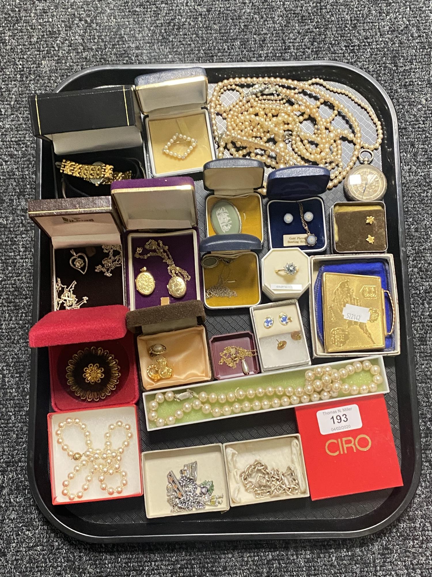 A tray of 9ct gold locket on gilt chain, silver fob watch, costume jewellery, compact,