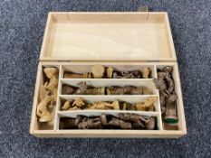 A wooden box containing resin chess pieces CONDITION REPORT: These are cast resin,