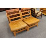 A pair of late 20th century beech and tan leather low chairs