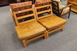 A pair of late 20th century beech and tan leather low chairs