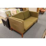 A mid 20th century Danish two seater settee in olive fabric on teak legs