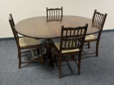 A circular pedestal Jaycee Oak extending dining table and four chairs