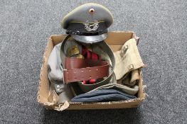 A box of militaria to include military caps, and hats,