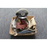 A box of militaria to include military caps, and hats,