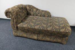 A contemporary chaise longue in paisley fabric