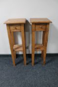 A pair of contemporary oak two tier plant stands fitted with a drawer