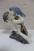 A Royal Copenhagen figure of a faun holding a parrot