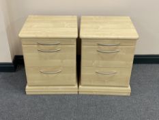 A pair of pine effect two drawer bedside chests with slides