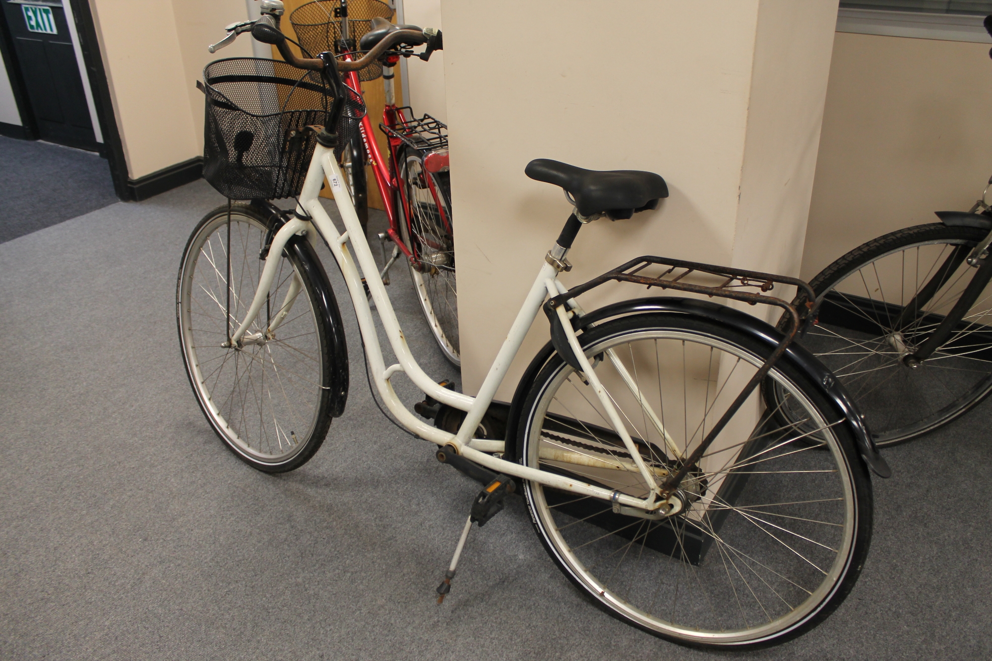 A lady's hybrid bike with front shopping basket (rear wheel locked)