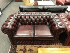 A Chesterfield style two seater oxblood settee,