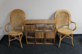 A pair of bamboo and wicker conservatory armchairs together with a set of teak shelves