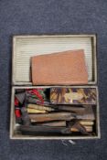 A vintage leather luggage case containing a quantity of joinery tools