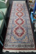 A fringed eastern carpet runner,