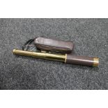 A brass and leather cased pocket telescope in carry case