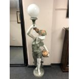 A pair of marble floor lamps modelled as maidens holding flowers,