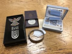 A silver bangle together with three pairs of earrings, Festival of Britain coin and a book mark.