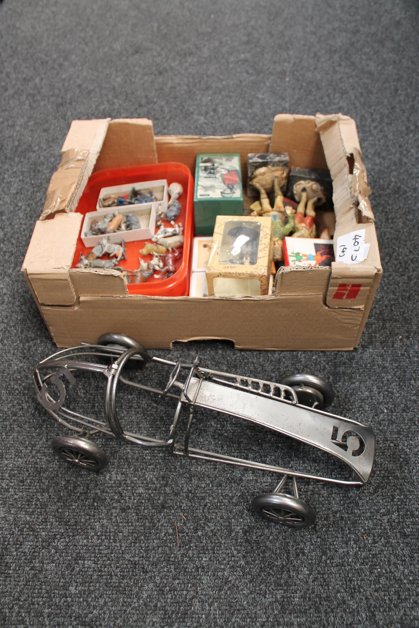 A box of wire metal model of a vintage racing car, boxed card games,