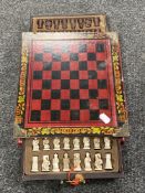 A Chinese lacquered chess board with pieces