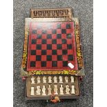 A Chinese lacquered chess board with pieces