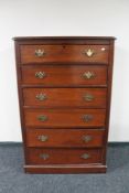 An Edwardian stained six drawer chest